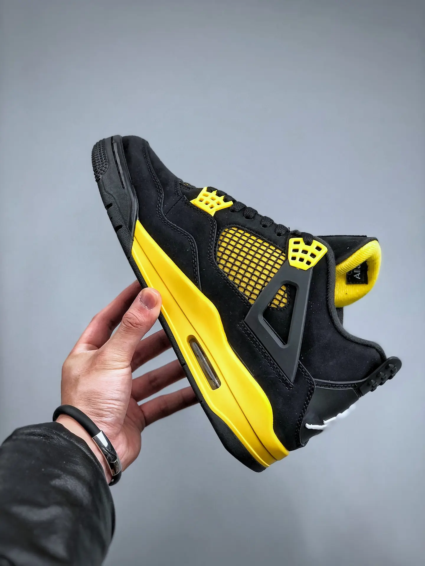 The Intriguing Allure of Air Jordan 4 Retro 'Thunder' Replica in Black and Yellow | YtaYta