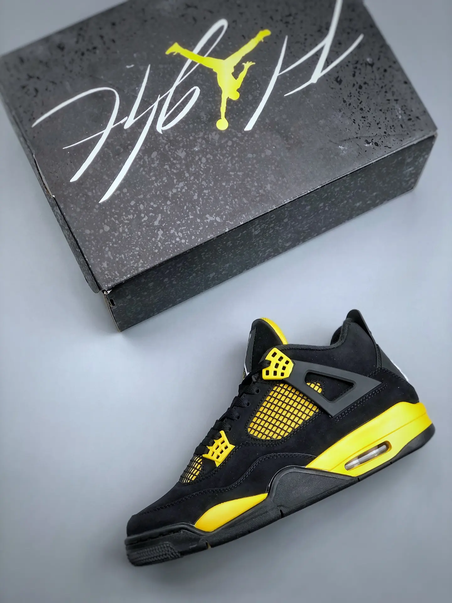 The Intriguing Allure of Air Jordan 4 Retro 'Thunder' Replica in Black and Yellow | YtaYta