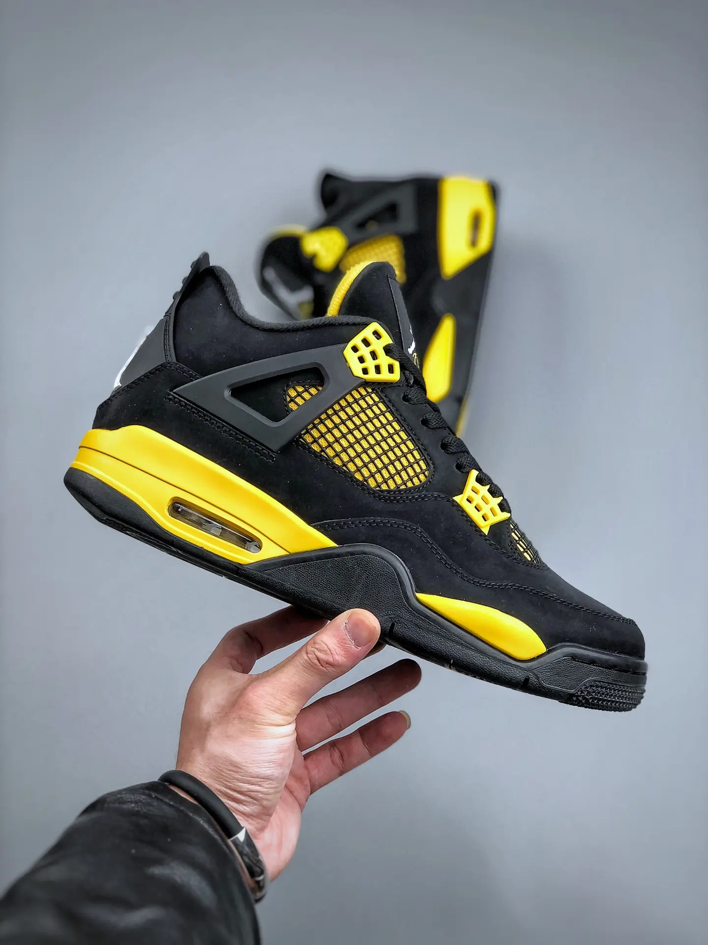 The Intriguing Allure of Air Jordan 4 Retro 'Thunder' Replica in Black and Yellow | YtaYta