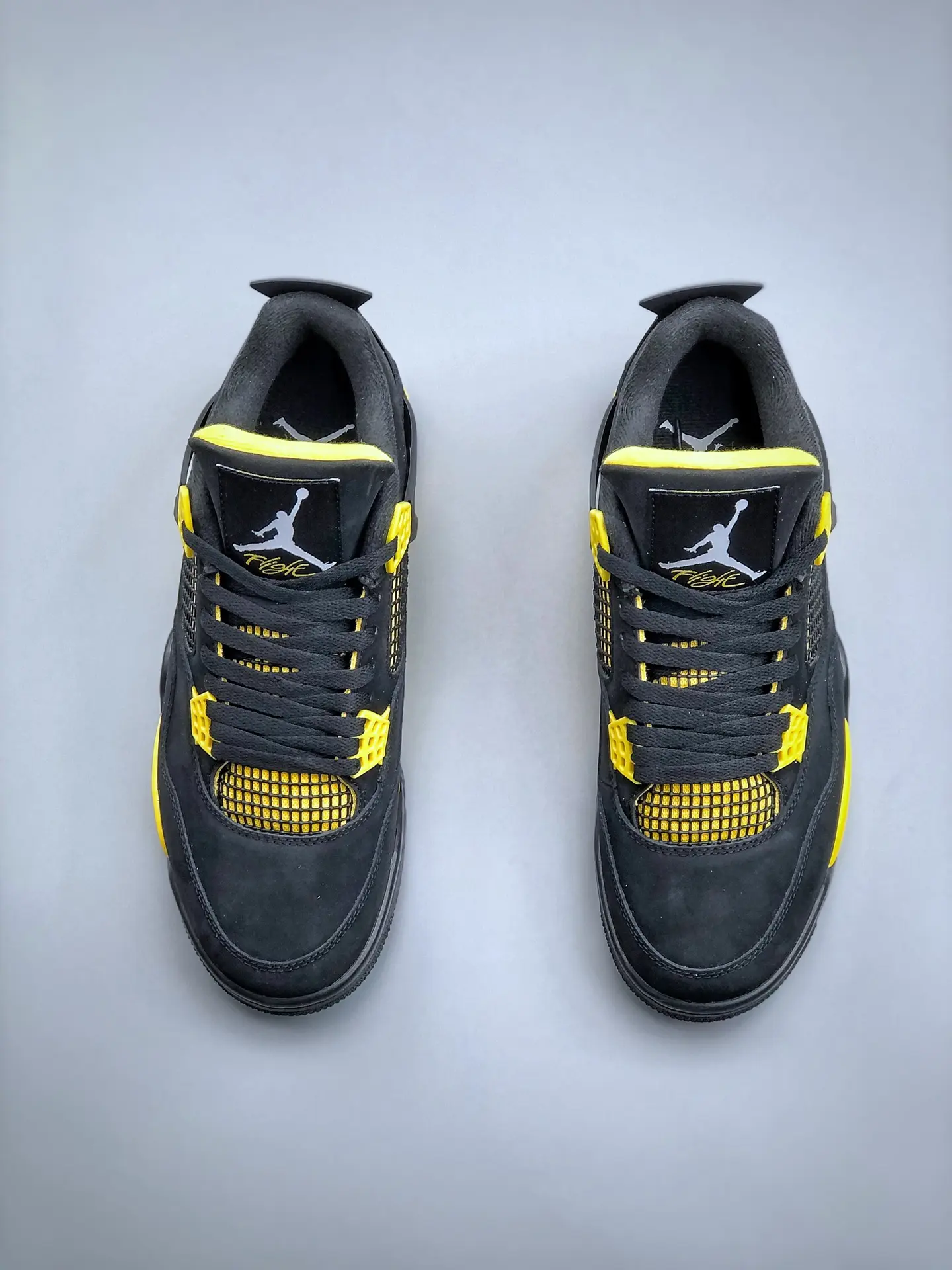 The Intriguing Allure of Air Jordan 4 Retro 'Thunder' Replica in Black and Yellow | YtaYta