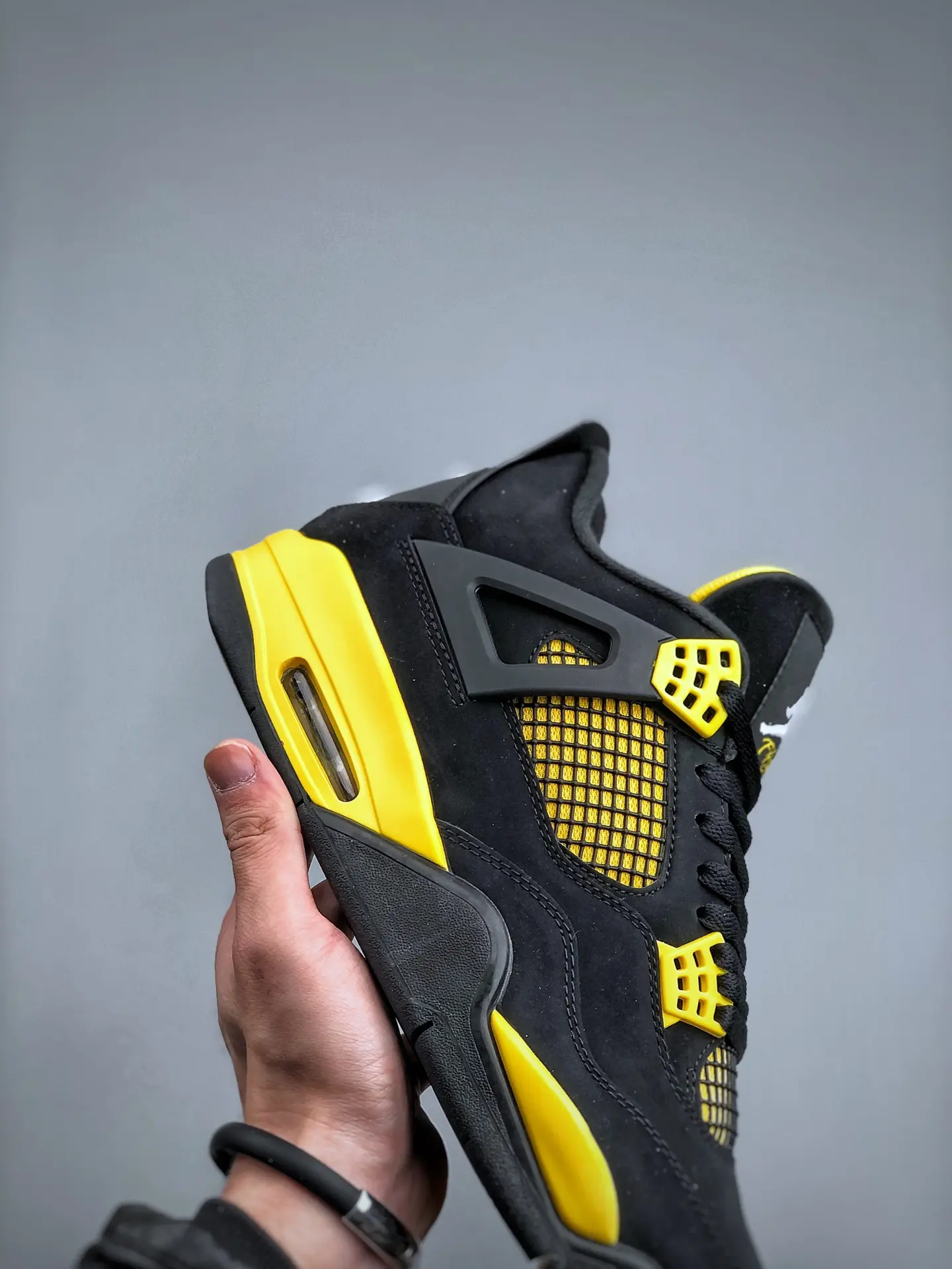 The Intriguing Allure of Air Jordan 4 Retro 'Thunder' Replica in Black and Yellow | YtaYta