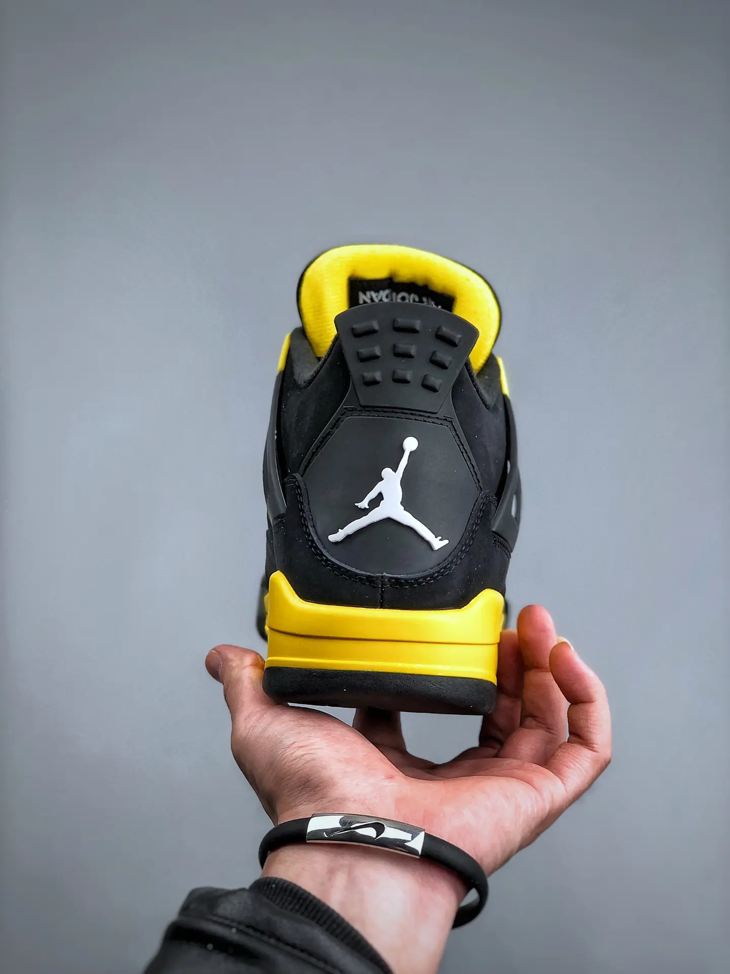 The Intriguing Allure of Air Jordan 4 Retro 'Thunder' Replica in Black and Yellow | YtaYta